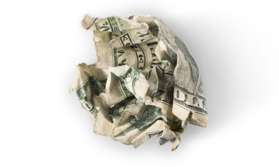 crumpled up dollar bill against white background